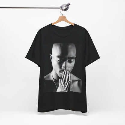 A black graphic t-shirt featuring a black and white streetwear rebel graphic of Tupac.