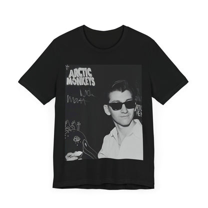 A black graphic t-shirt featuring a black and white portrait photo of Alex Turner from Arctic Monkeys, showing his signature look.