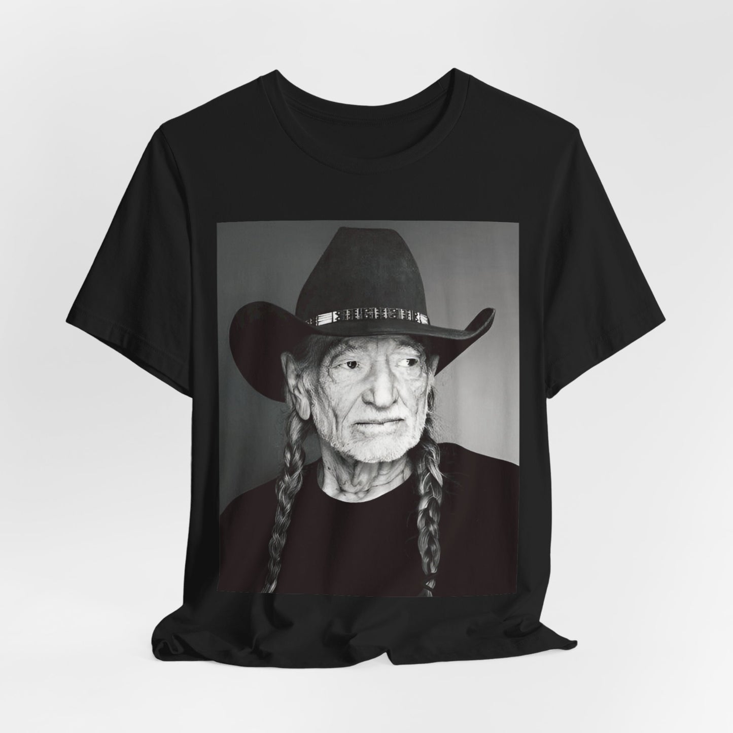A black graphic t-shirt featuring a graphic of Willie Nelson with his iconic guitar 'Trigger'.