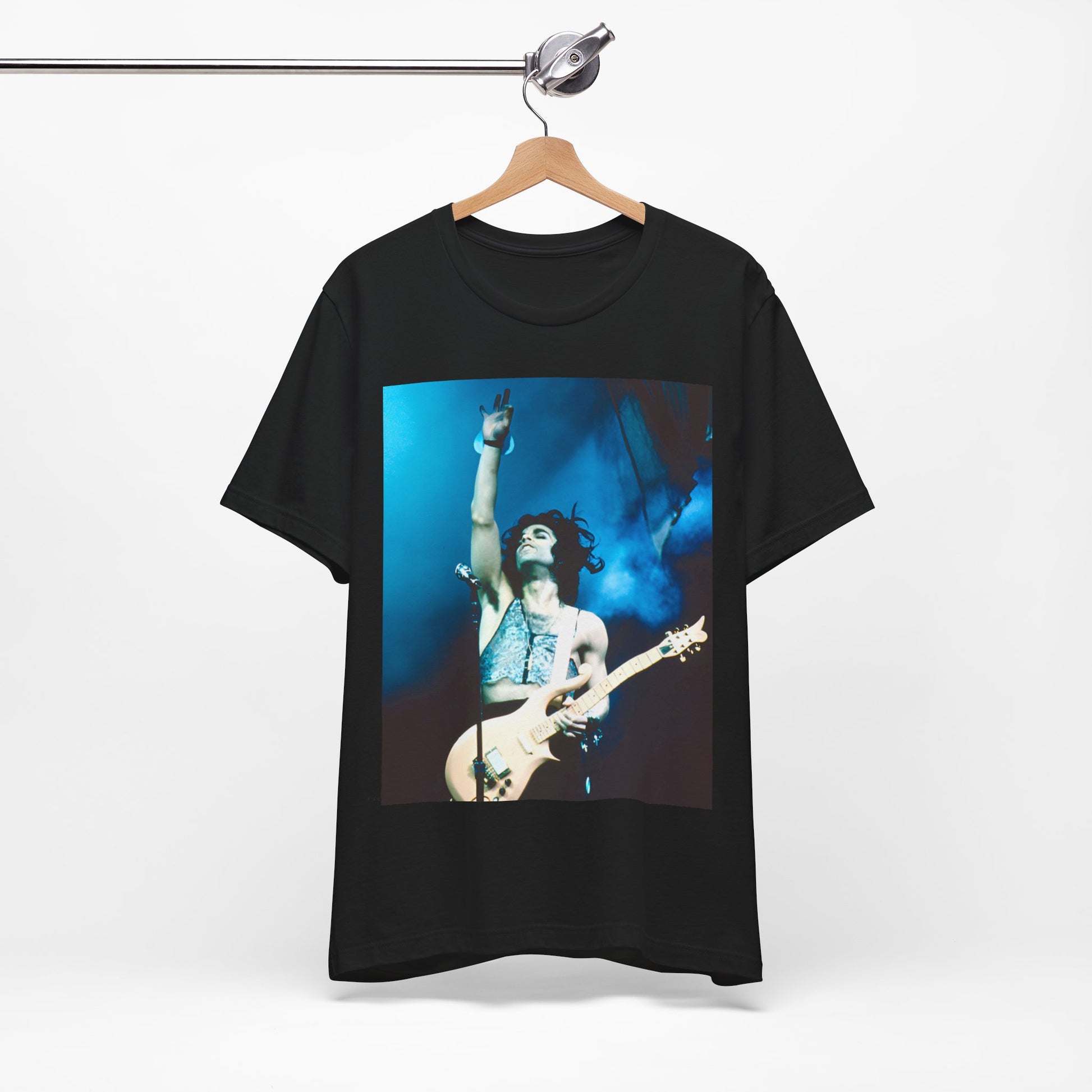 A black graphic t-shirt featuring a graphic of Prince as a guitar god and virtuoso performer.