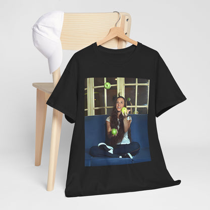 A black graphic t-shirt featuring a candid photo of Alanis Morissette sitting on a couch, looking relaxed or thoughtful.