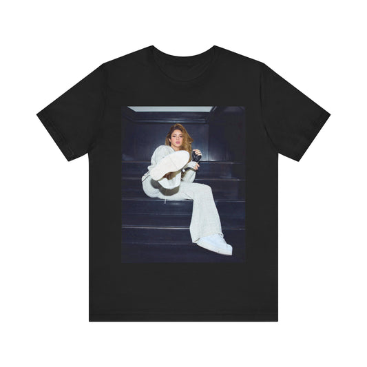 A black graphic t-shirt featuring a vintage Latin pop icon graphic of Shakira.