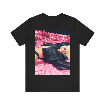 A black graphic t-shirt featuring a vintage aesthetic graphic related to Karol G's 'Tusa' era.