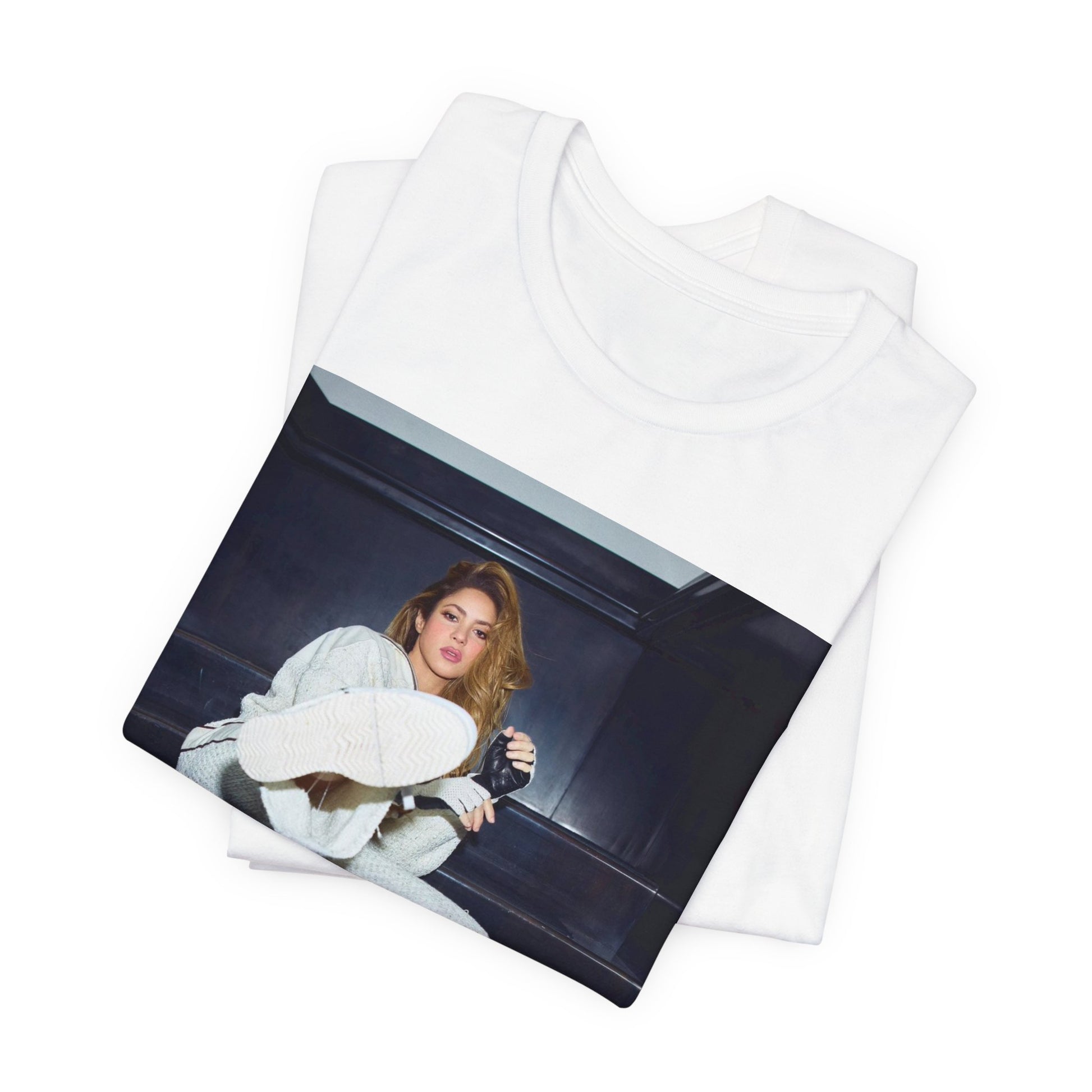 A black graphic t-shirt featuring a vintage Latin pop icon graphic of Shakira.