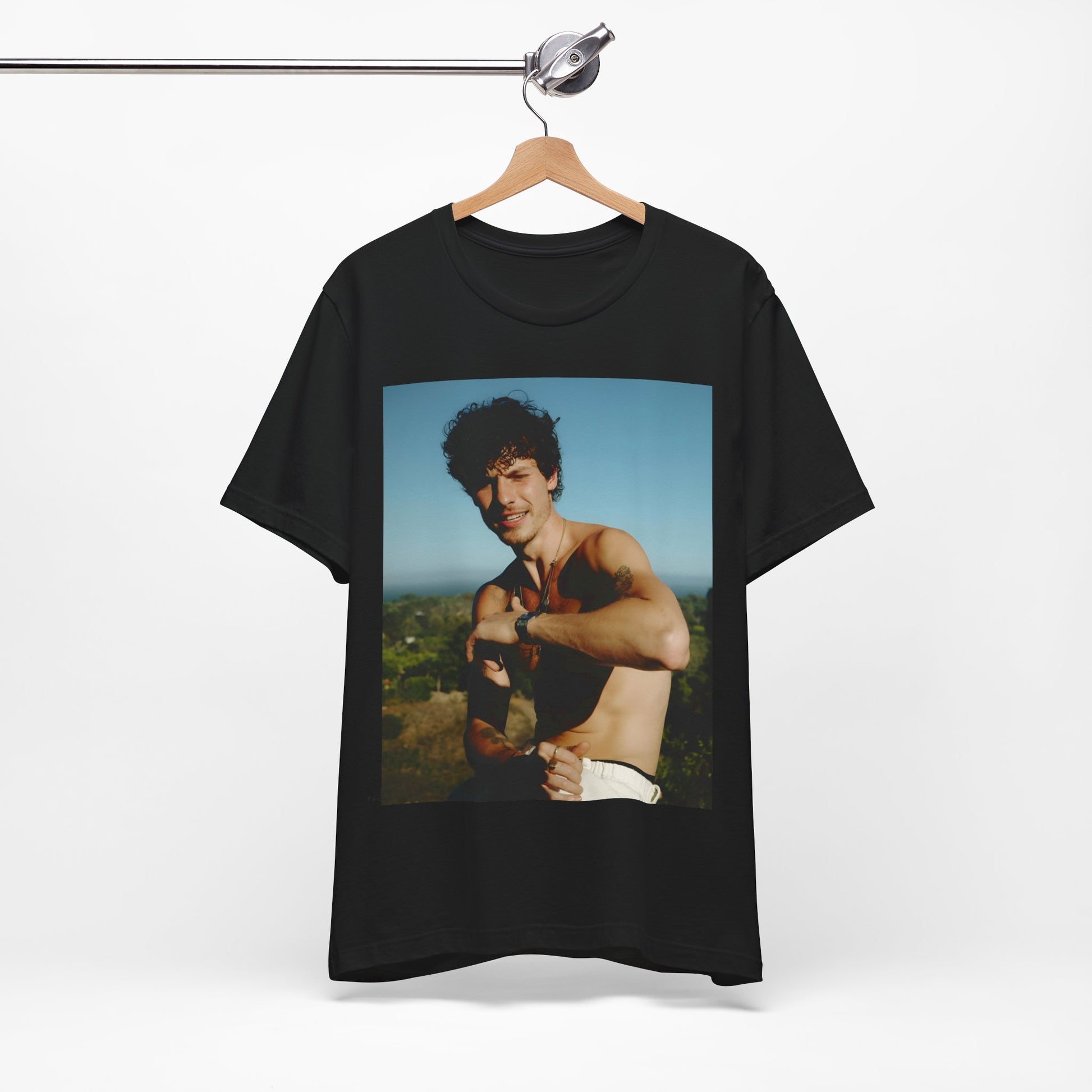 A black graphic t-shirt featuring a graphic of Shawn Mendes with a chill pop star look.
