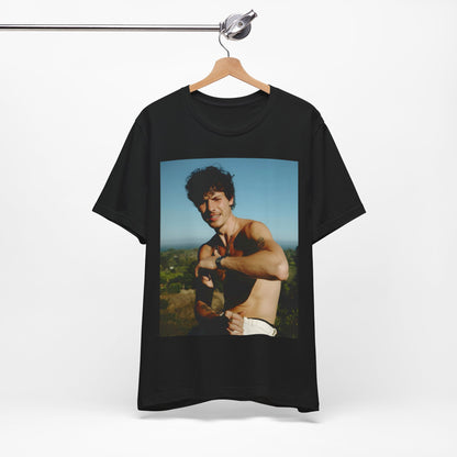 A black graphic t-shirt featuring a graphic of Shawn Mendes with a chill pop star look.