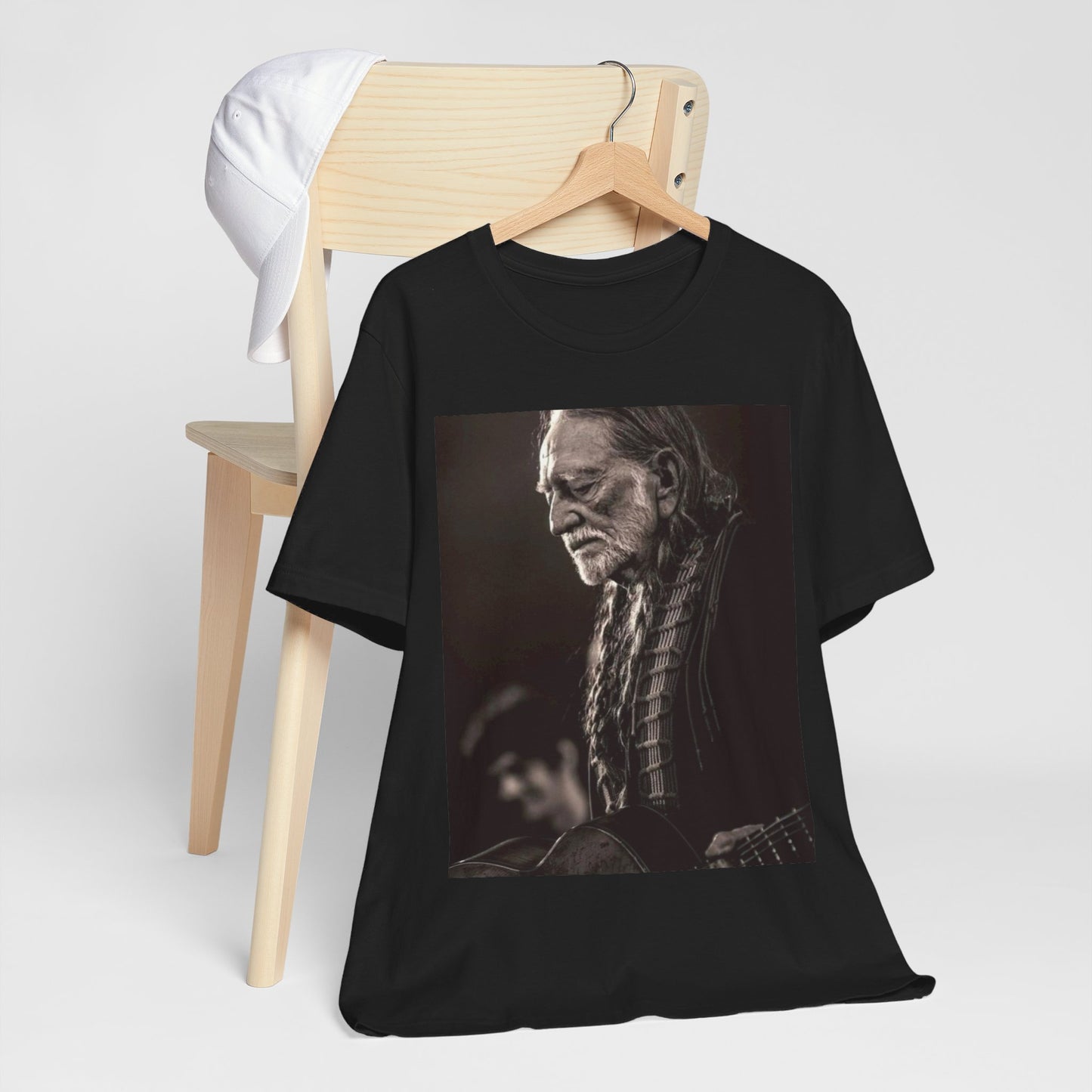 A black graphic t-shirt featuring a vintage country legend graphic of Willie Nelson.
