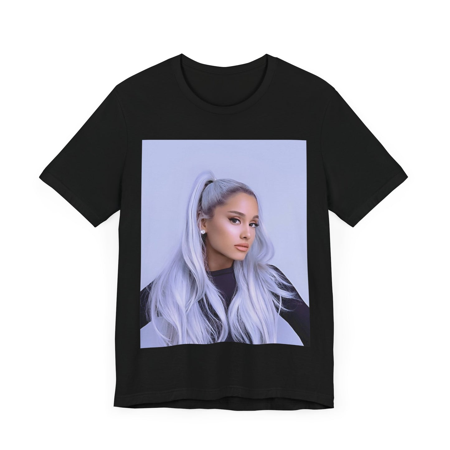 A black graphic t-shirt featuring a stylized graphic of Ariana Grande, possibly with a crown or 'Pop Queen' text, emphasizing her iconic status.