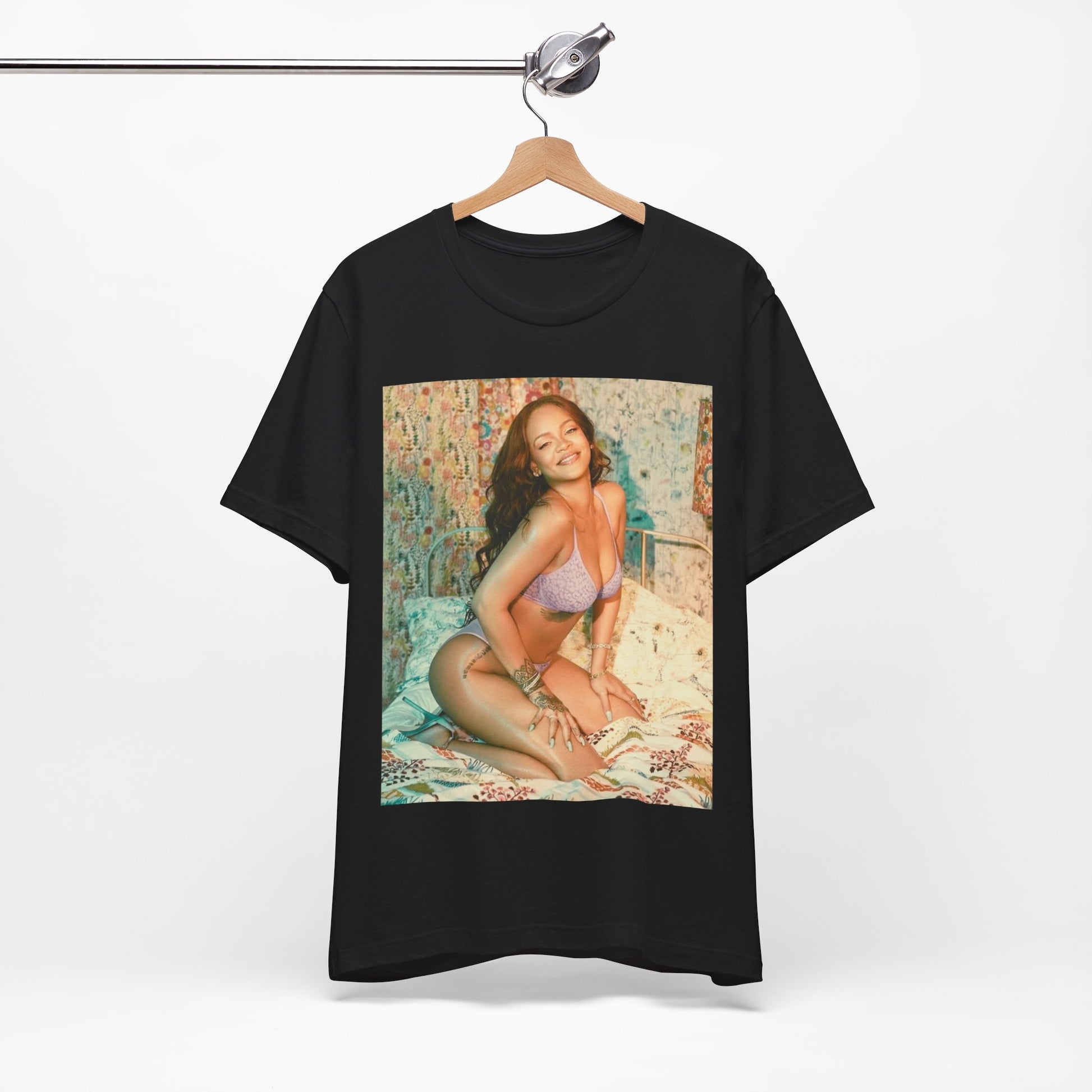 A black graphic t-shirt featuring a graphic of Rihanna with a beauty aesthetic.