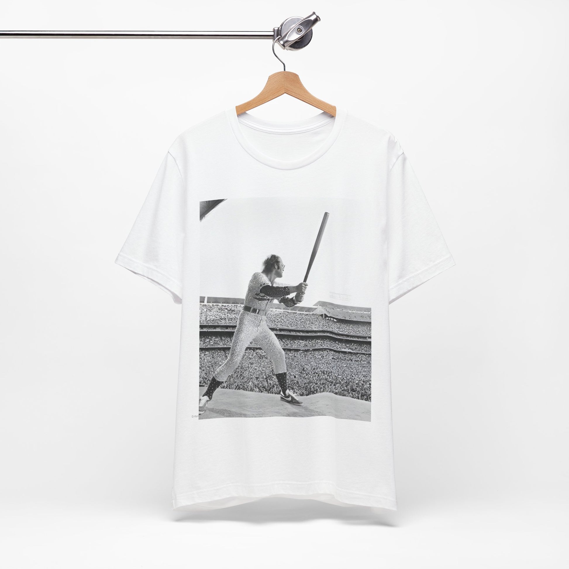 A black graphic t-shirt featuring a black and white graphic or photo related to Elton John's 1975 tour in America.