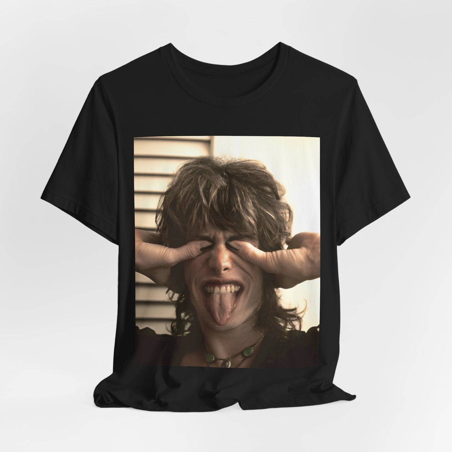 A black graphic t-shirt featuring a vintage 70s band photo of Aerosmith, showing the members in their iconic early looks.