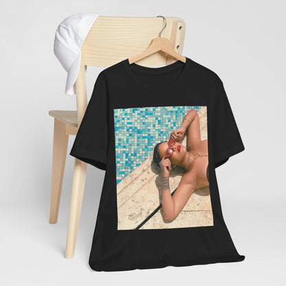 A black graphic t-shirt featuring a graphic of Rihanna in swimwear as a pop star queen.