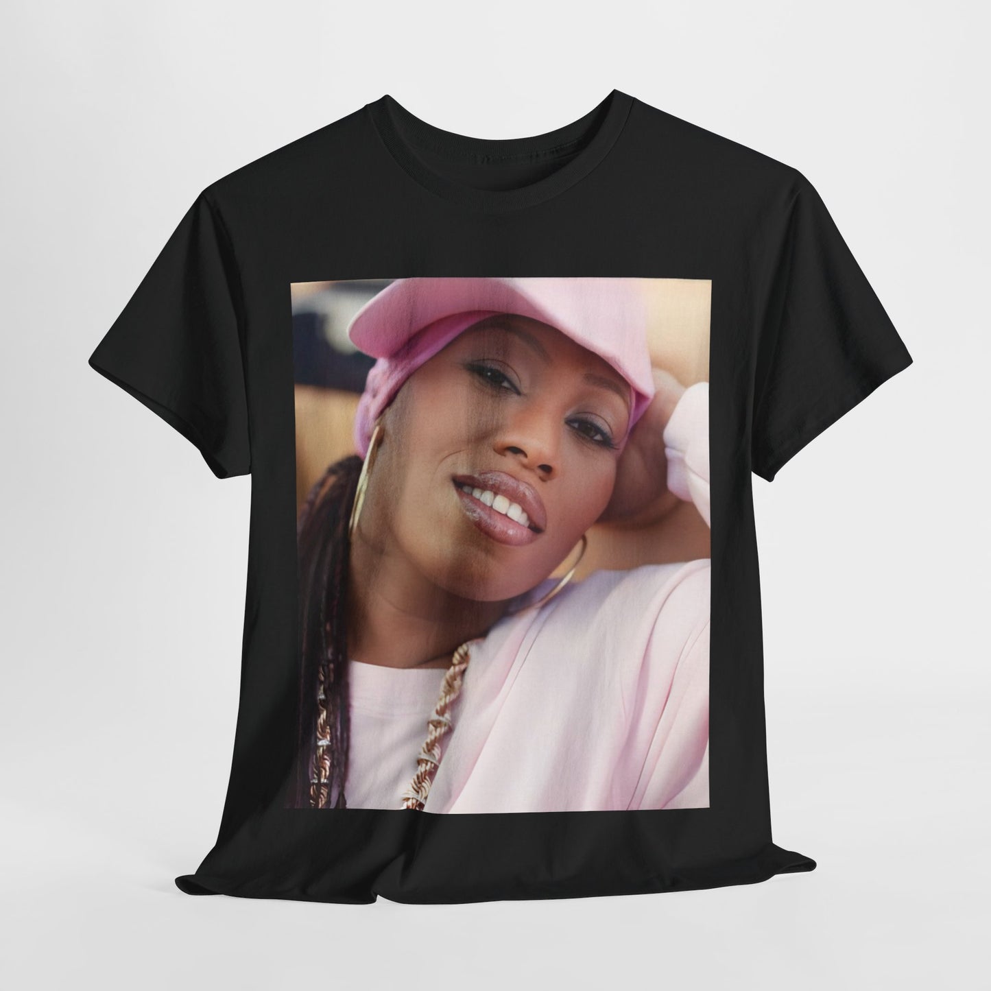 A black graphic t-shirt featuring a 90s rap graphic of Missy Elliott from her early days, emphasizing a raw style.