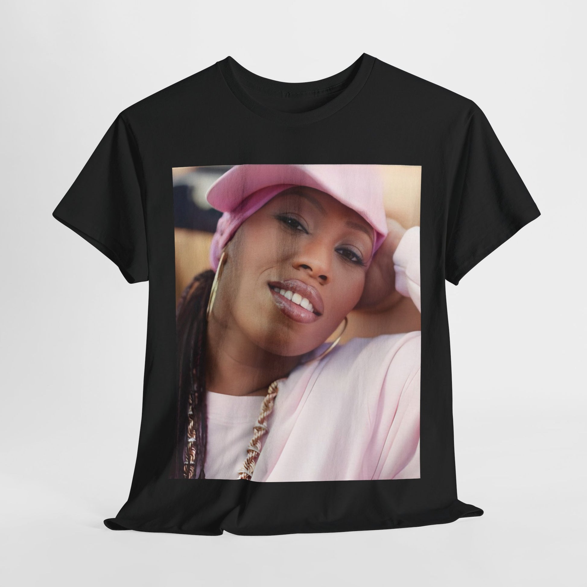 A black graphic t-shirt featuring a 90s rap graphic of Missy Elliott from her early days, emphasizing a raw style.
