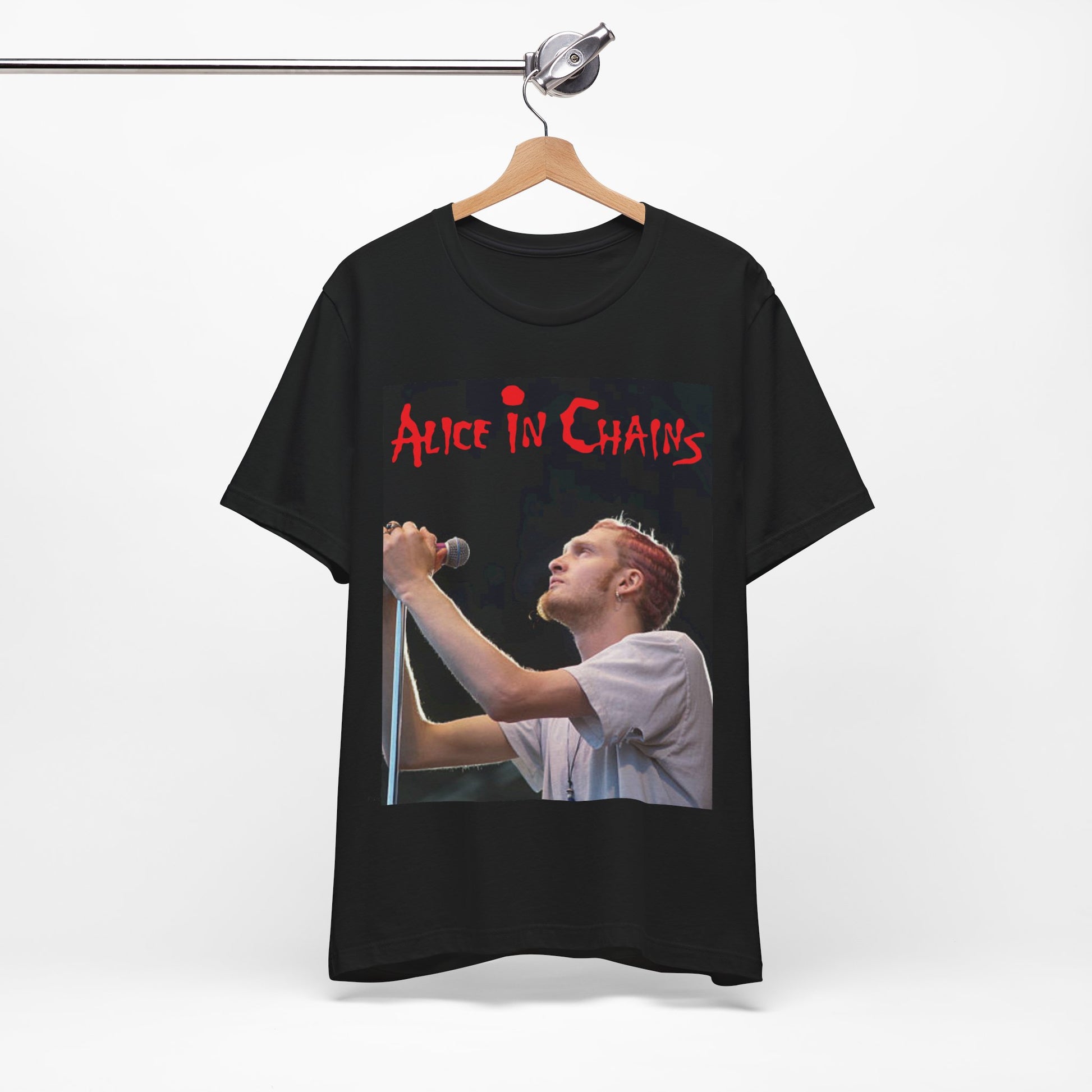 A black graphic t-shirt featuring the Alice In Chains logo in red, in a 90s grunge style.