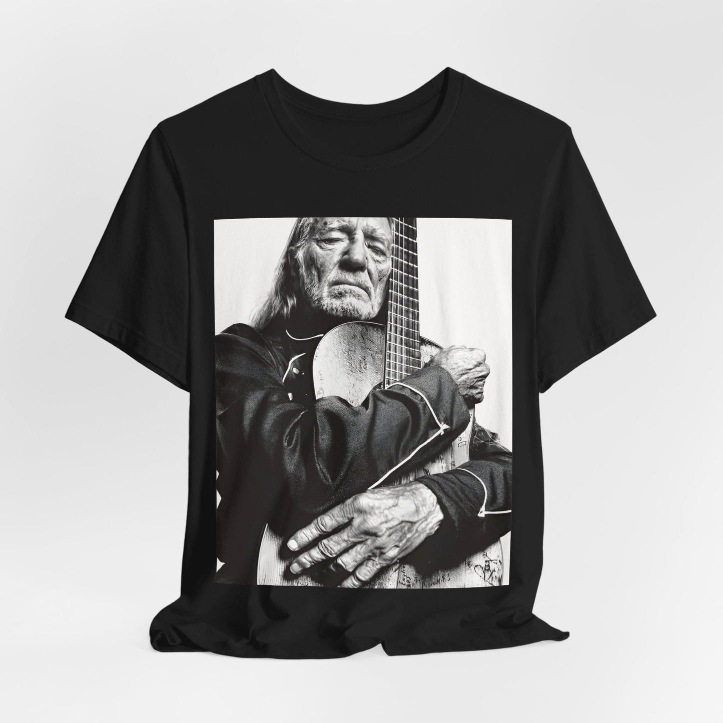 A black graphic t-shirt featuring a vintage country legend graphic of Willie Nelson.