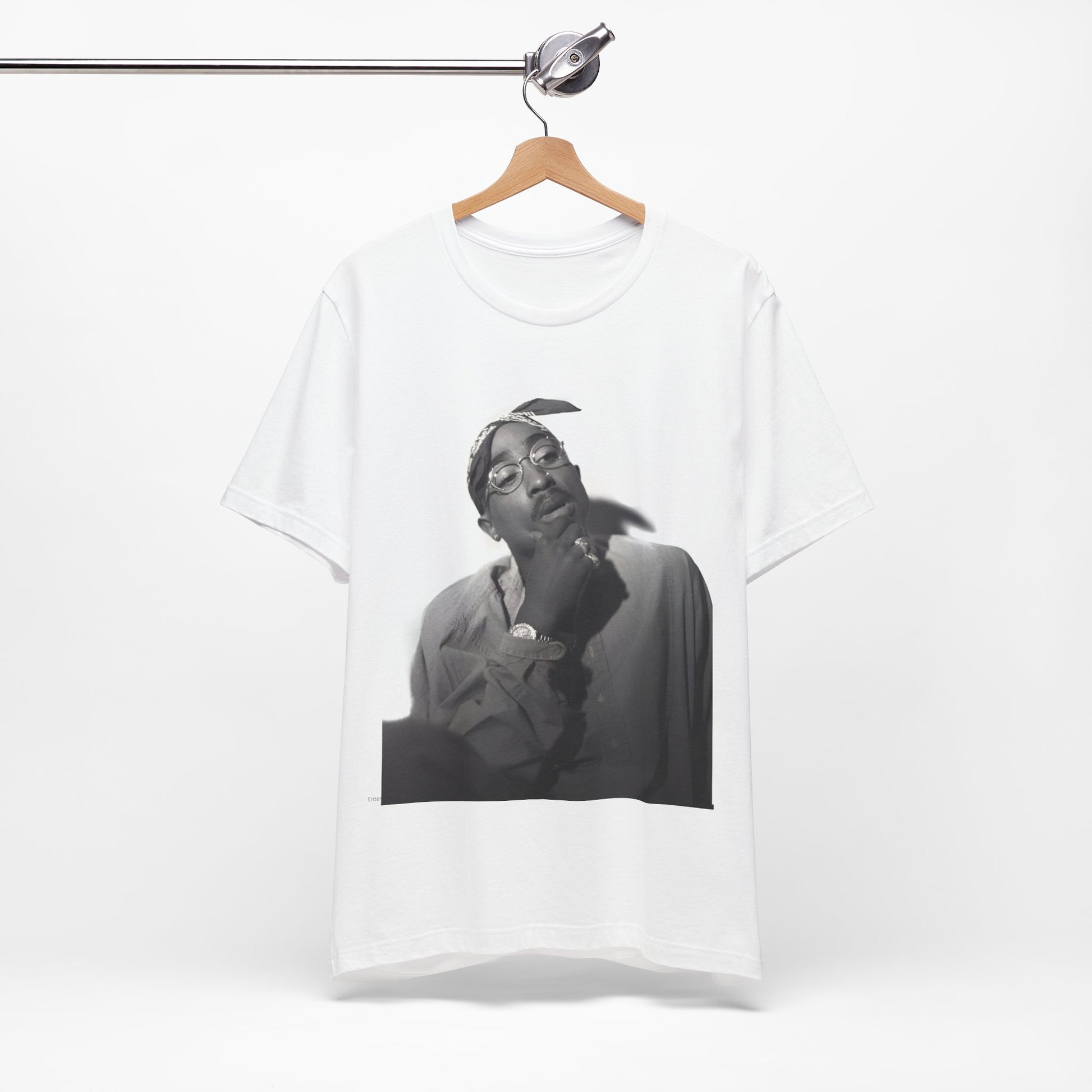A black graphic t-shirt featuring a classic 90s West Coast rap graphic of Tupac.