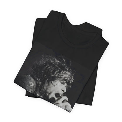 A black graphic t-shirt featuring a retro 70s-style illustration or photo of Aerosmith, designed to evoke their 'On Tour' presence, possibly with band members on stage or tour bus imagery.