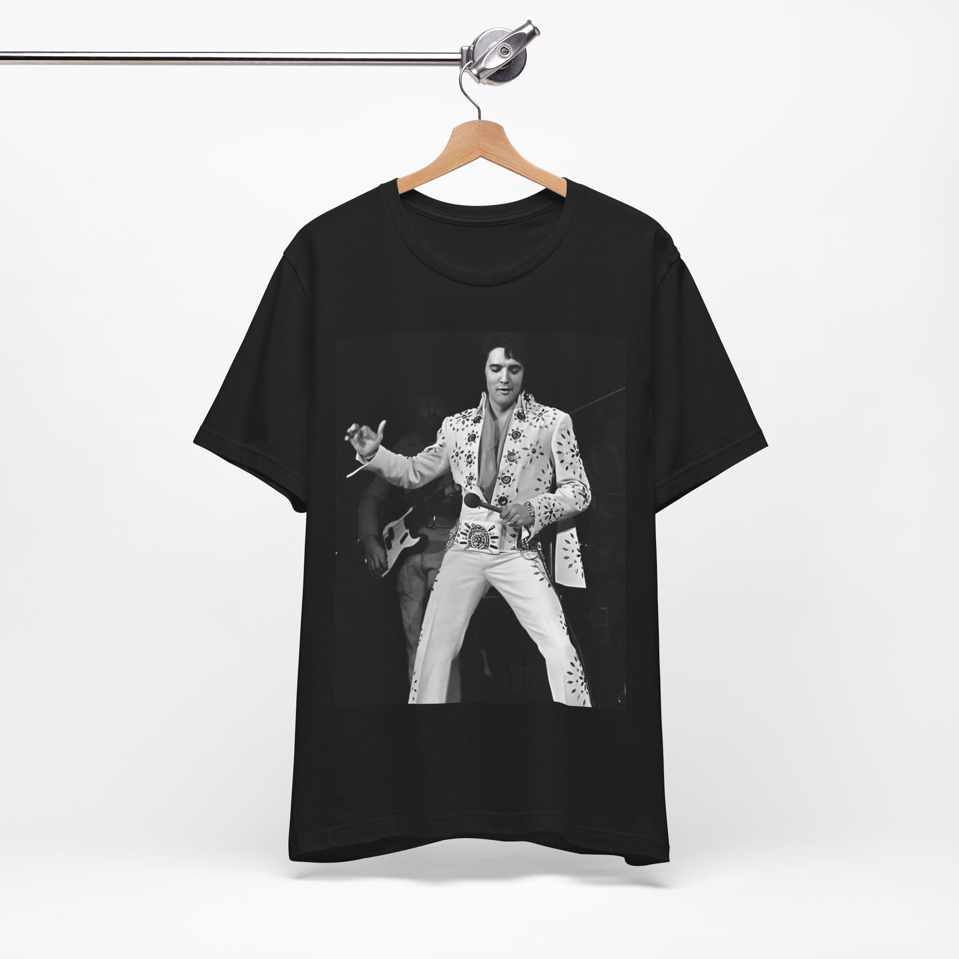 A black graphic t-shirt featuring a stylized graphic of Elvis Presley as The King of Rock 'n' Roll.