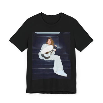 A black graphic t-shirt featuring a vintage Latin pop icon graphic of Shakira.