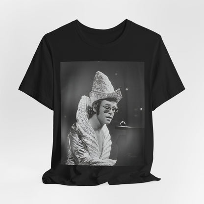 A black graphic t-shirt featuring a 70s pop aesthetic graphic of Elton John.