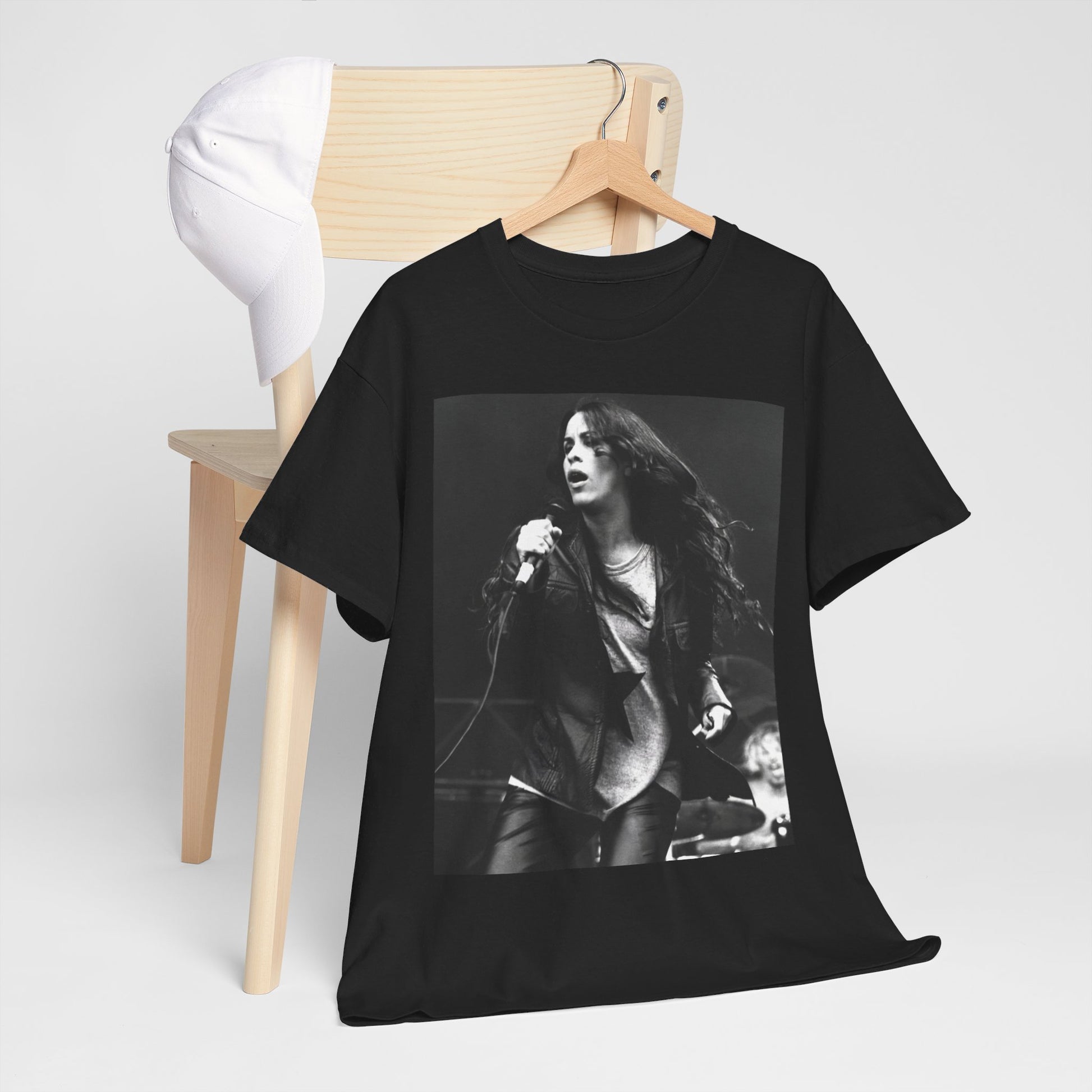 A black graphic t-shirt featuring a 90s-style concert graphic of Alanis Morissette, related to her "Jagged Little Pill" era tours.