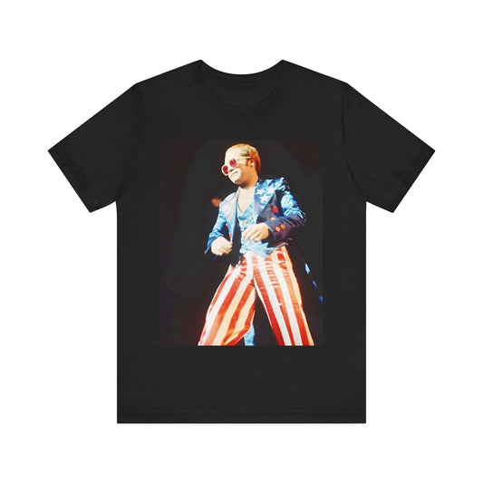 A black graphic t-shirt featuring a graphic related to Elton John's 70s America tour.