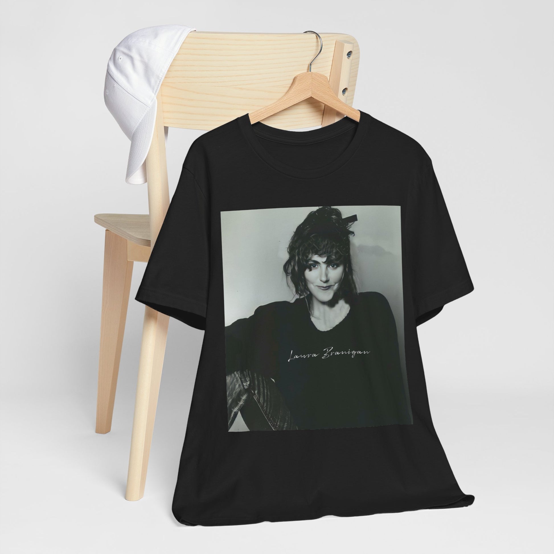 A black graphic t-shirt featuring a casual 80s pop fan graphic of Laura Branigan.