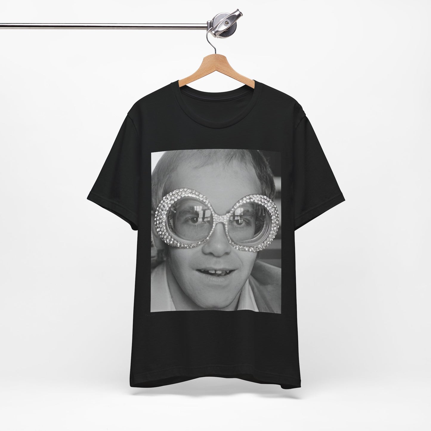 A black graphic t-shirt featuring a graphic of Elton John emphasizing his iconic glasses and fashion.