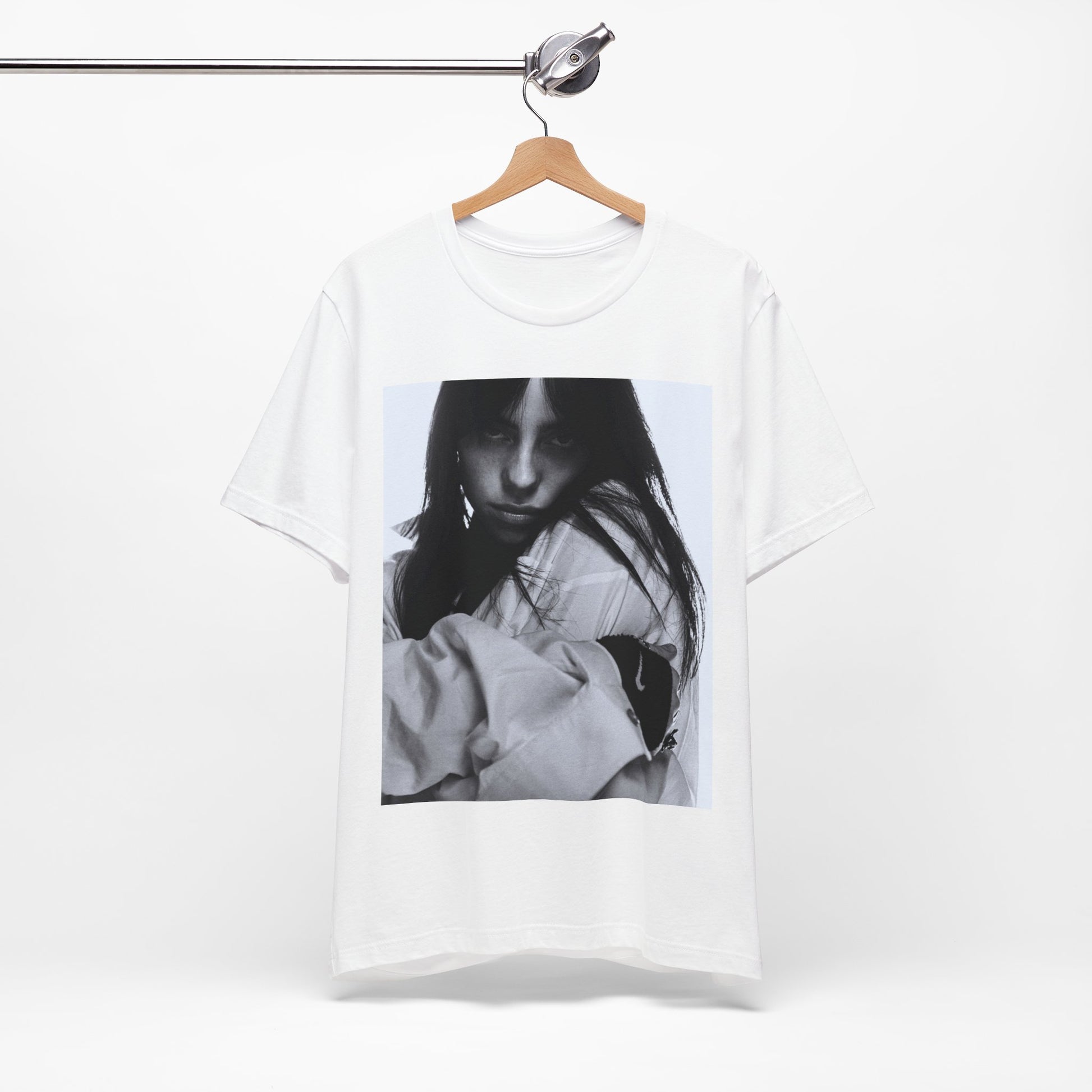 Billie Eilish posing in her signature oversized designer streetwear, printed on a graphic t-shirt.