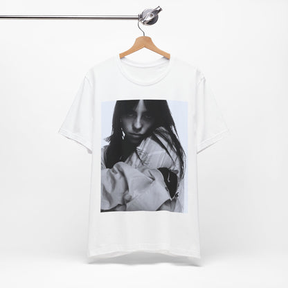 Billie Eilish posing in her signature oversized designer streetwear, printed on a graphic t-shirt.