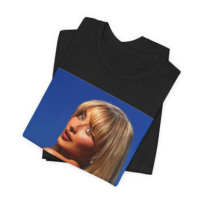 A black graphic t-shirt featuring a stylized graphic of Sabrina Carpenter, designed with a modern pop aesthetic.