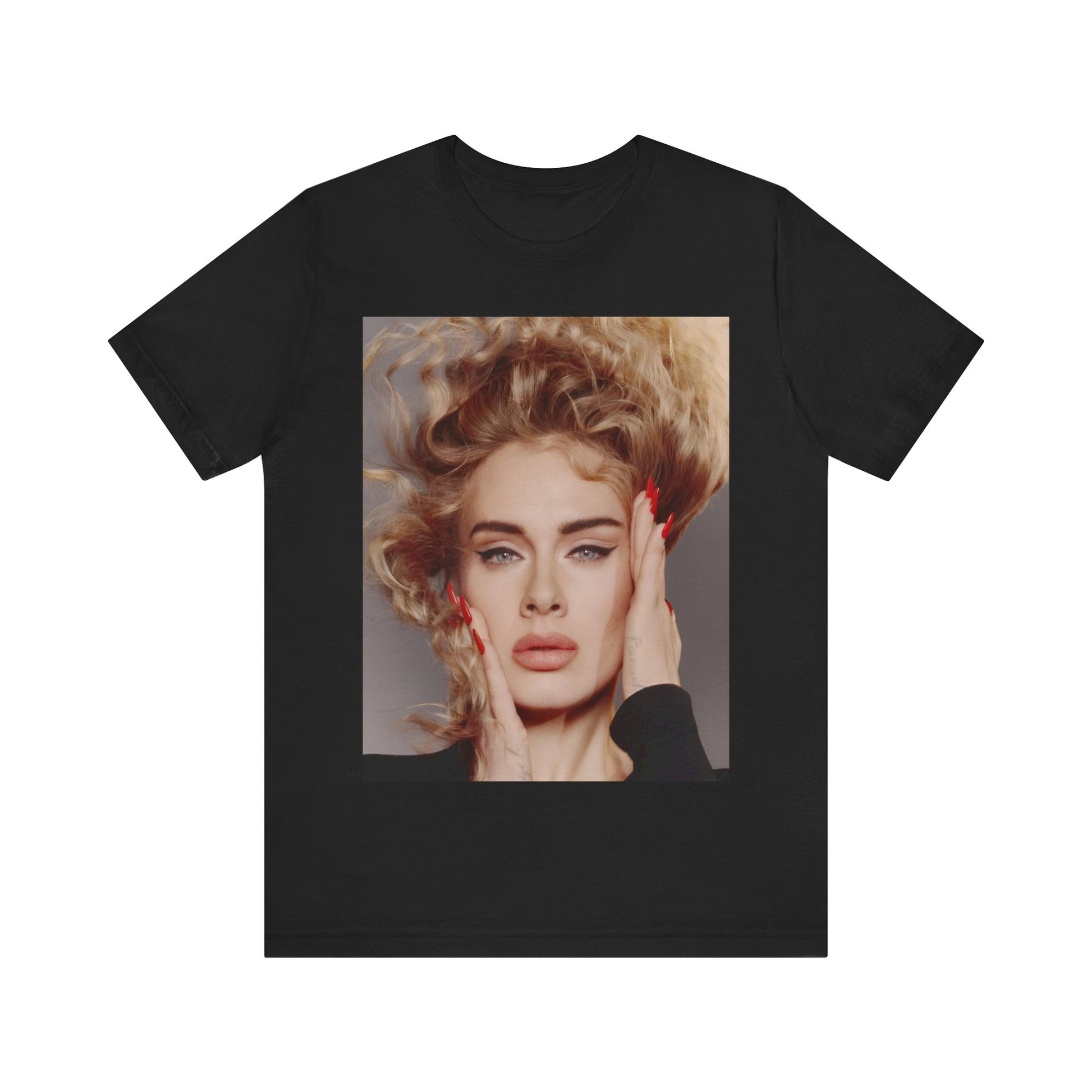 A black graphic t-shirt featuring a detailed, artistic black and white portrait of Adele with her hair dramatically caught in a breeze around her face and her hands gently placed on her cheeks.