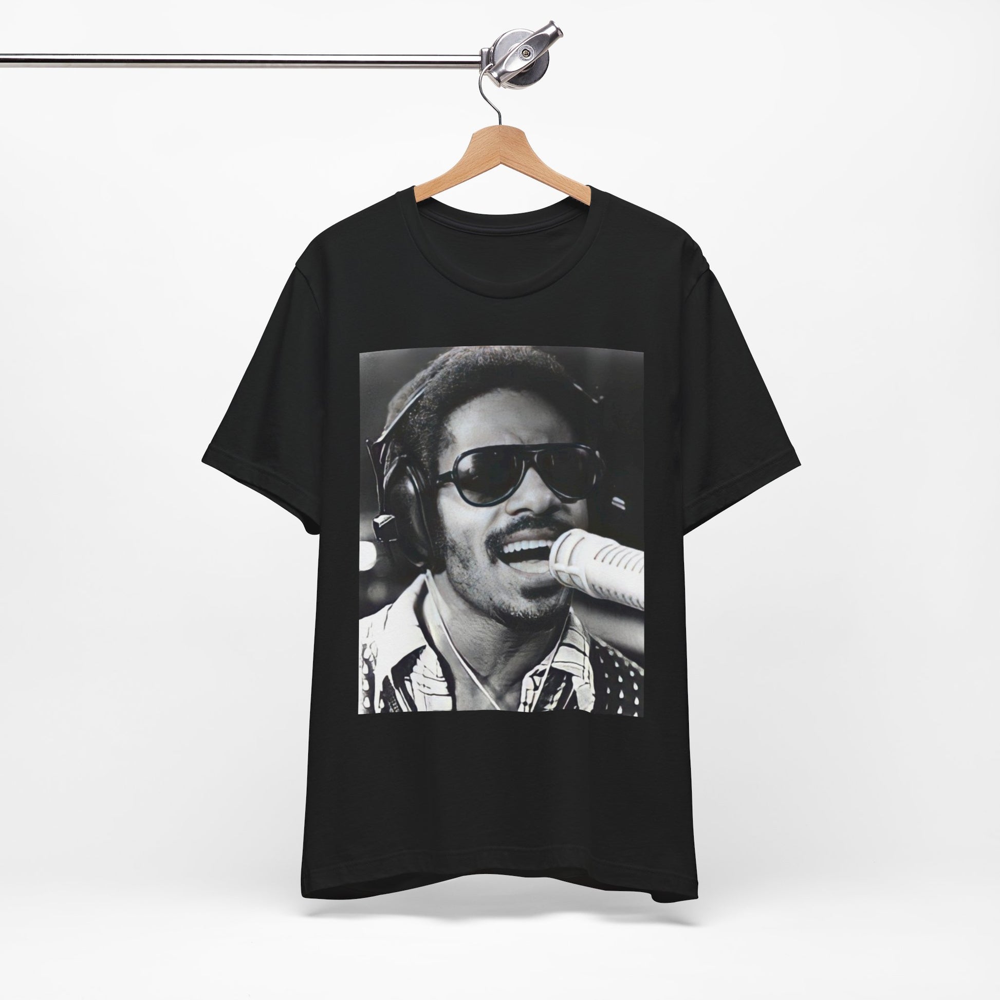A black graphic t-shirt featuring a graphic of Stevie Wonder as a timeless visionary.