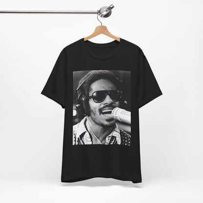 A black graphic t-shirt featuring a graphic of Stevie Wonder as a timeless visionary.