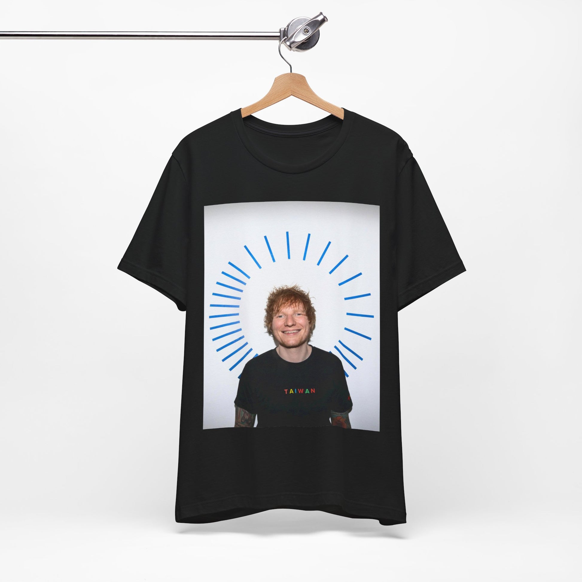 A black graphic t-shirt featuring a classic photo portrait of Ed Sheeran in a folk-pop style.