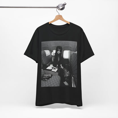 A black graphic t-shirt featuring a vintage 70s-style illustration of an airplane with Aerosmith branding, representing their tour plane from that era.