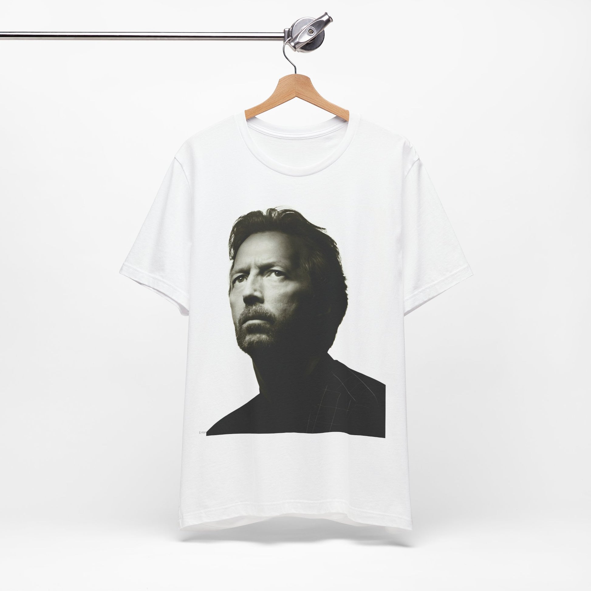 A black graphic t-shirt featuring a retro black and white portrait photo of Eric Clapton.