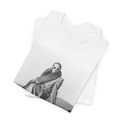 A black graphic t-shirt featuring a black and white photo of Elton John playing the piano.
