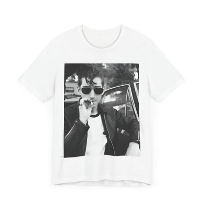 A black graphic t-shirt featuring a classic rock-style graphic of the Arctic Monkeys, possibly with band members in a stylized design.