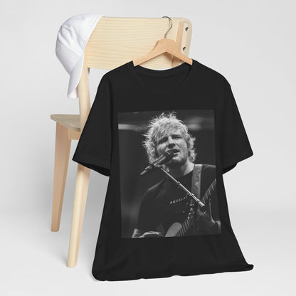A black graphic t-shirt featuring a black and white photo of Ed Sheeran performing live.