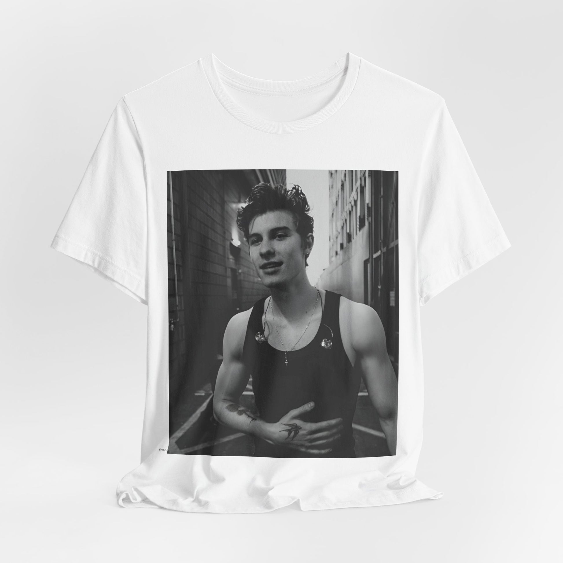 A black graphic t-shirt featuring a vintage black and white portrait graphic or photo of Shawn Mendes.