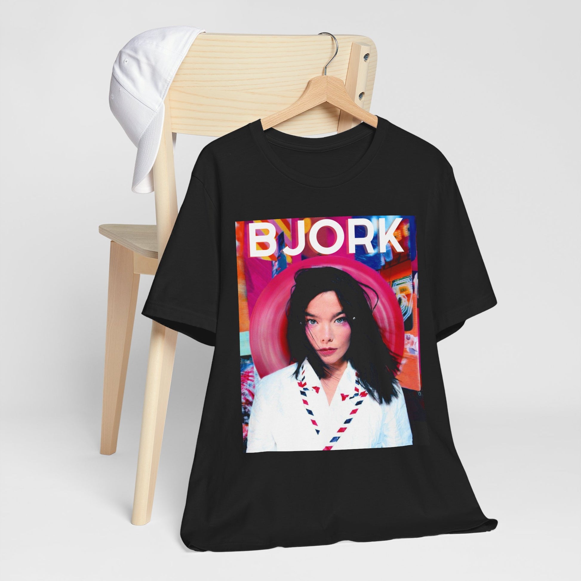 A black graphic t-shirt featuring an artistic or aesthetic pop art graphic of Bjork, with vibrant colors or bold lines.