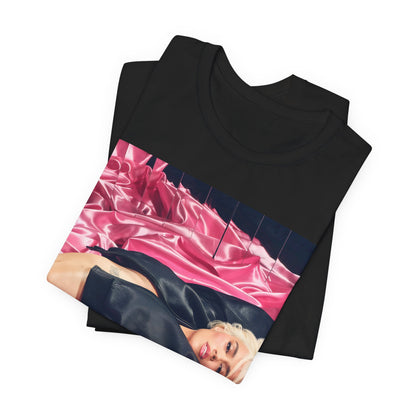 A black graphic t-shirt featuring a vintage aesthetic graphic related to Karol G's 'Tusa' era.