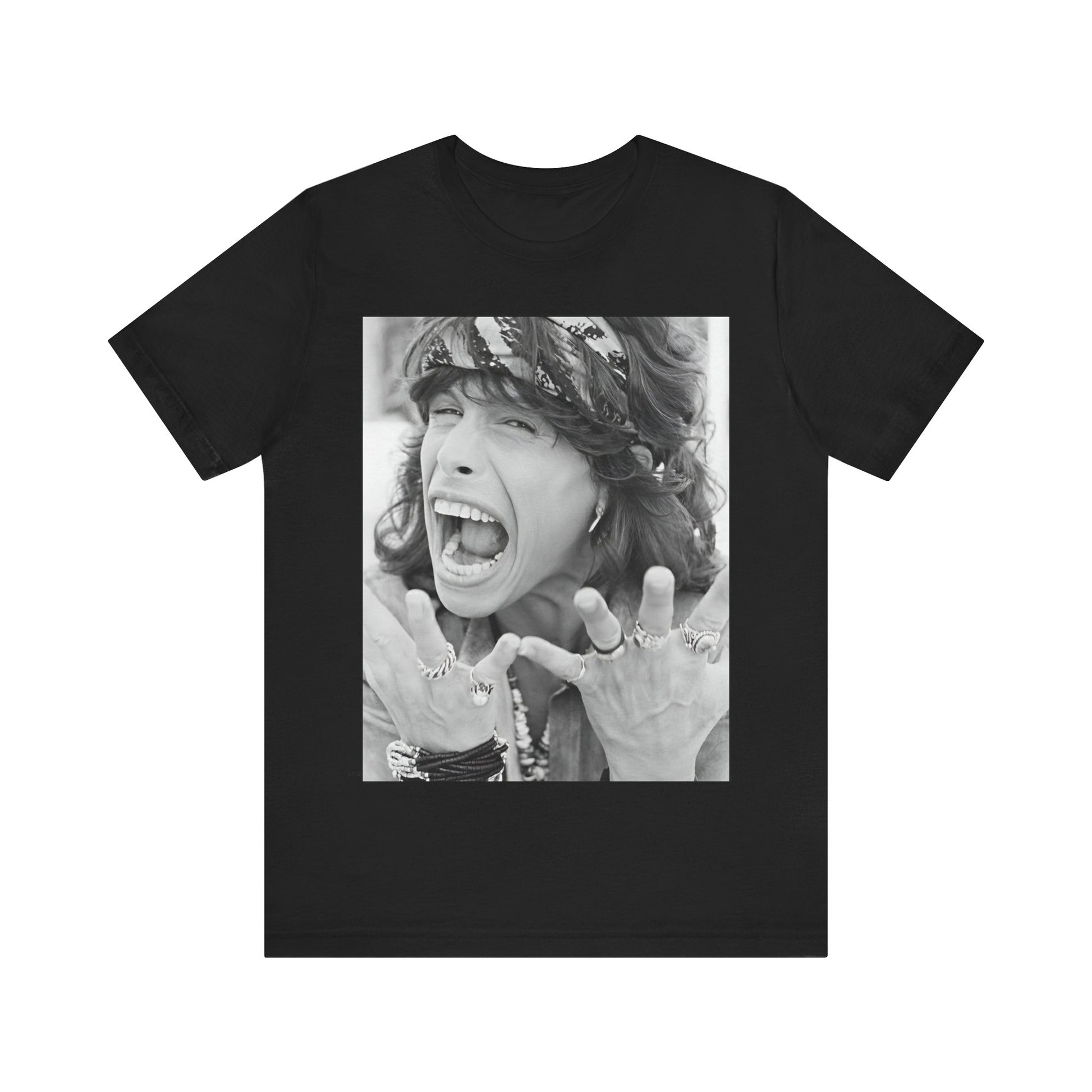 A black graphic t-shirt featuring a candid, dynamic photo of Aerosmith band members on tour in the 1970s, possibly showing action or interaction on stage or backstage.