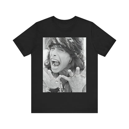 A black graphic t-shirt featuring a candid, dynamic photo of Aerosmith band members on tour in the 1970s, possibly showing action or interaction on stage or backstage.