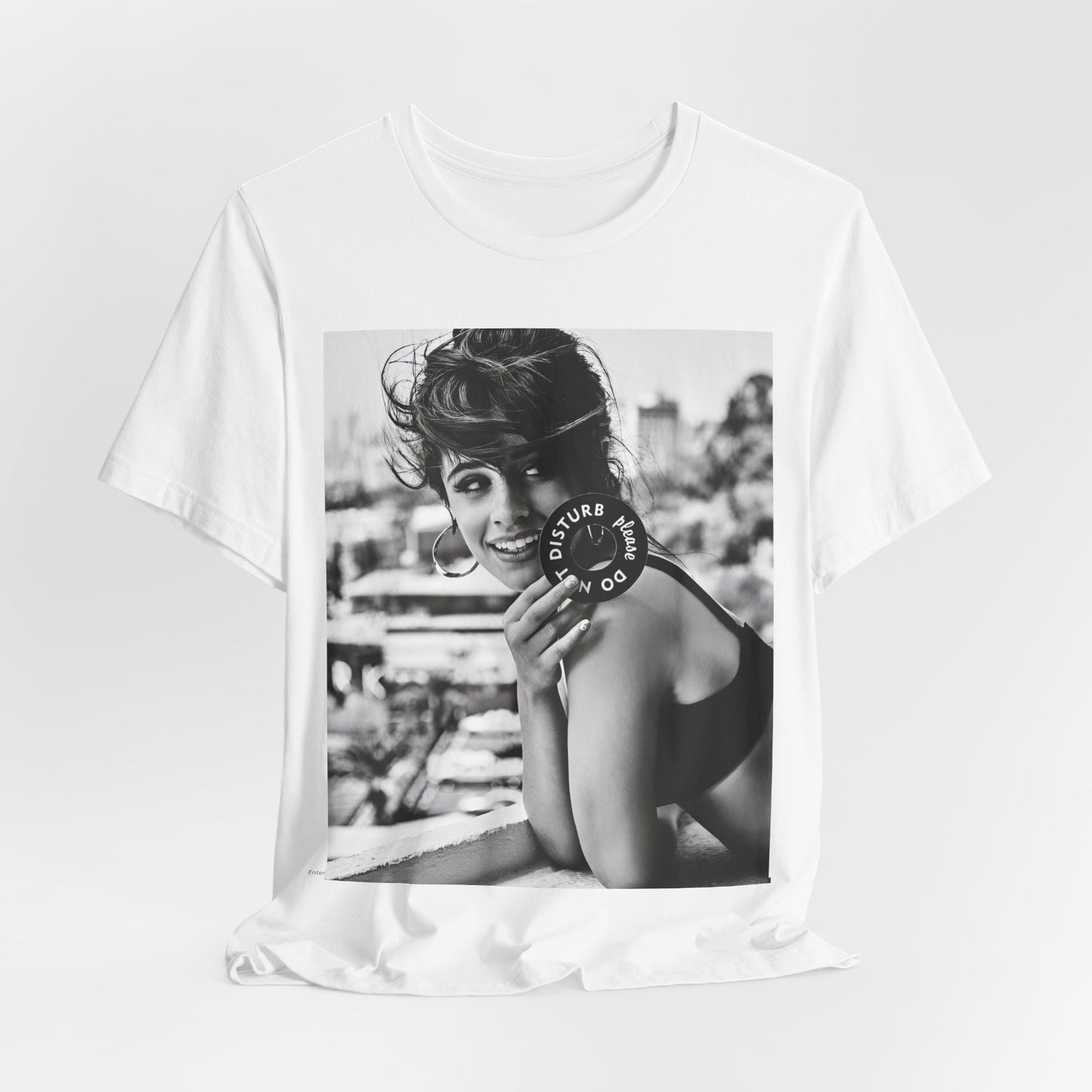 A black graphic t-shirt featuring a black and white photo or graphic of Camila Cabello in an iconic style.