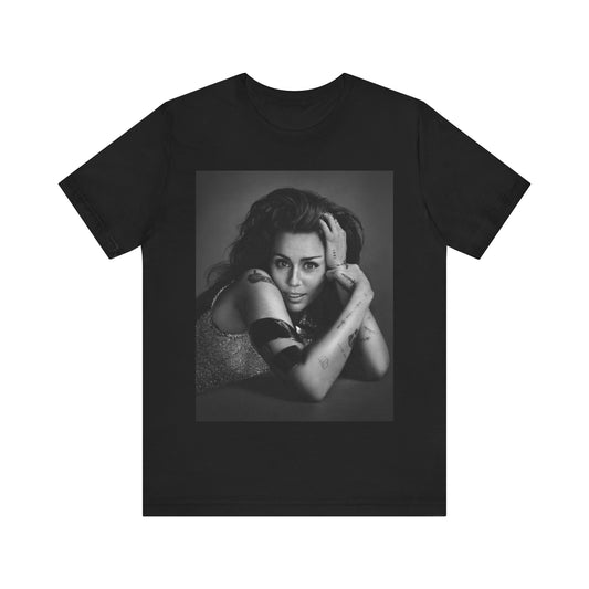 A black graphic t-shirt featuring a black and white portrait graphic of Miley Cyrus.