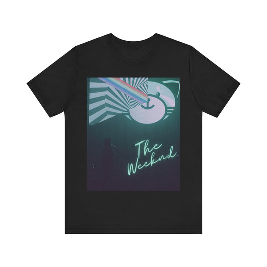 A black graphic t-shirt featuring a vintage concert graphic of The Weeknd from his 'Kiss Land' era.