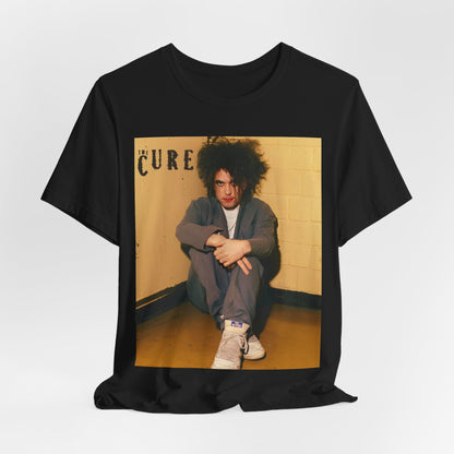 A black graphic t-shirt featuring a bold goth rock superstar graphic of The Cure.